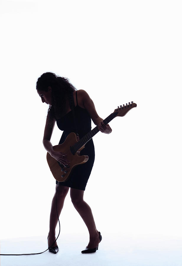 Silhouette Of Woman Playing Guitar Photograph by Pm Images