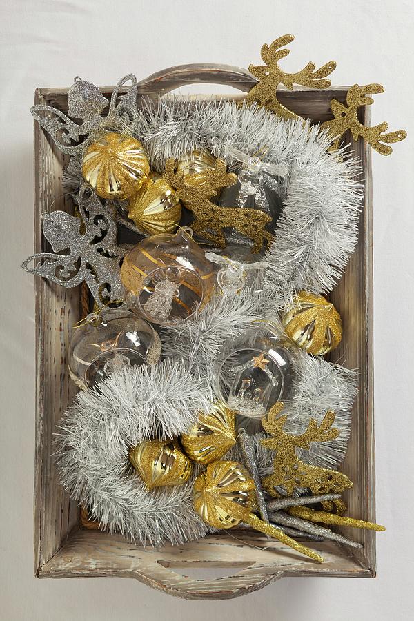 Silver And Gold Christmas Decorations On Wooden Tray Photograph by Studio Lipov