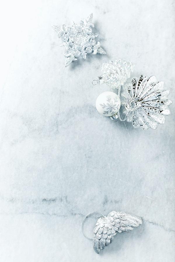 Silver Christmas Decorations On Marble Surface Photograph by B.&.e.dudzinski