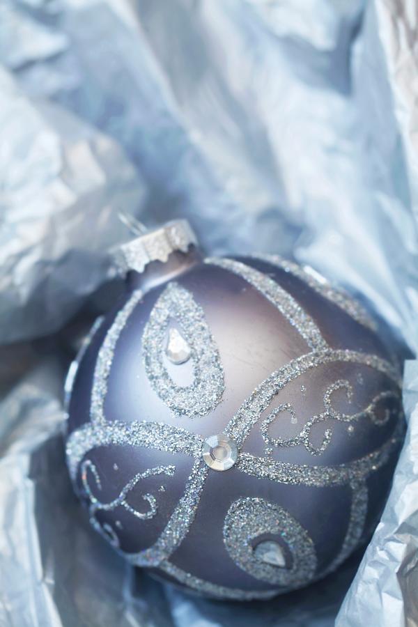 Silver Christmas Tree Bauble Nestled In Paper Photograph by Barbara Pheby