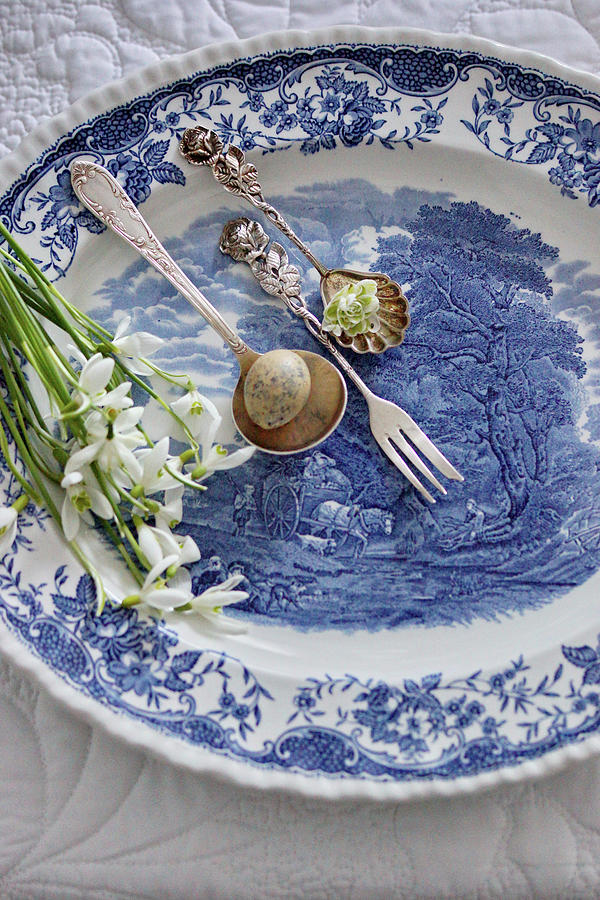 Silver Cutlery And Snowdrops On Plate With Landscape Motif Photograph by Angelica Linnhoff