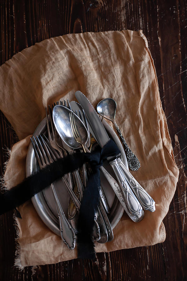 Silver Cutlery Tied With Bow On Tray On Brown Cloth Photograph by Alicja Koll