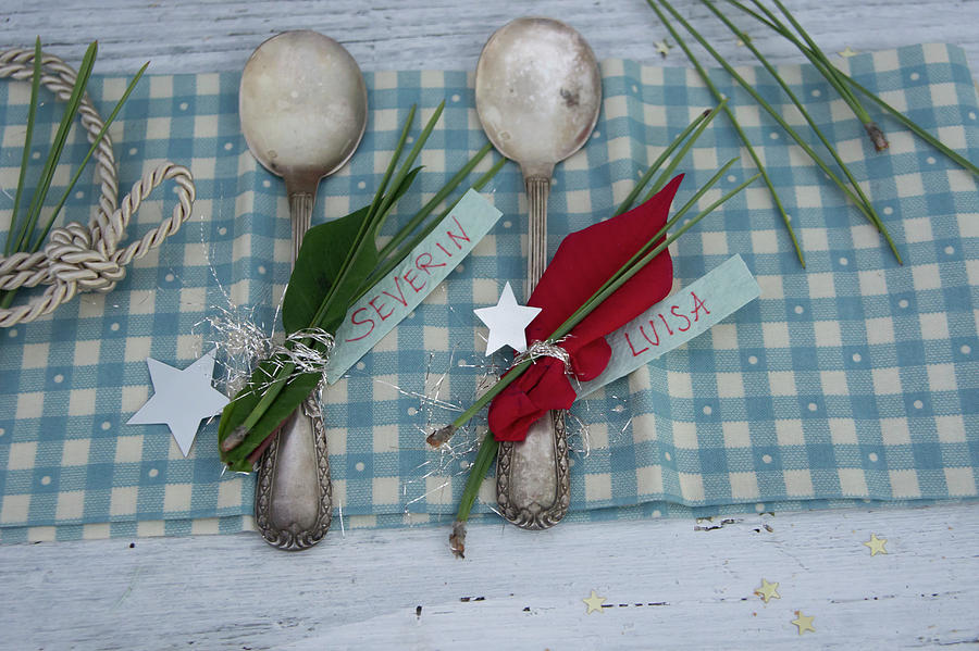Silver Spoons Decorated With Poinsettia And Pine Needles Used As Place Cards Photograph by Martina Schindler