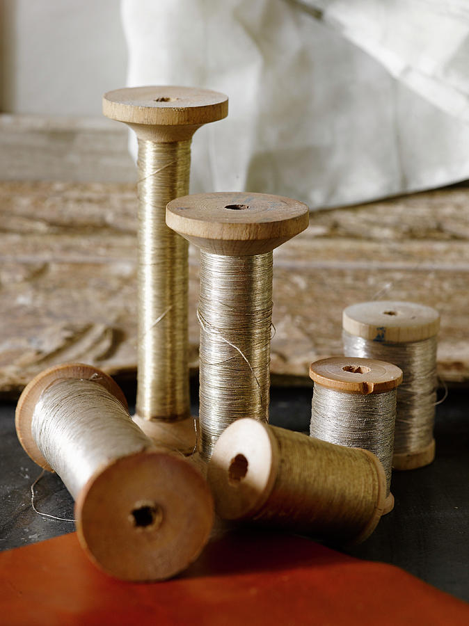 Silver Thread On Old Wooden Spools Photograph by Catherine Gratwicke