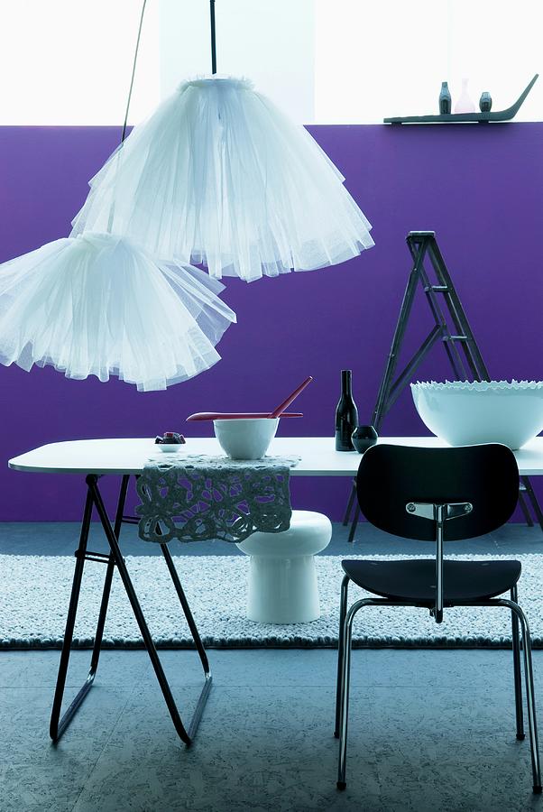 Simple Dining Table And Contemporary Tulle Lampshades In Front Of Purple Wall And Grey Long-pile Rug Photograph by Matteo Manduzio
