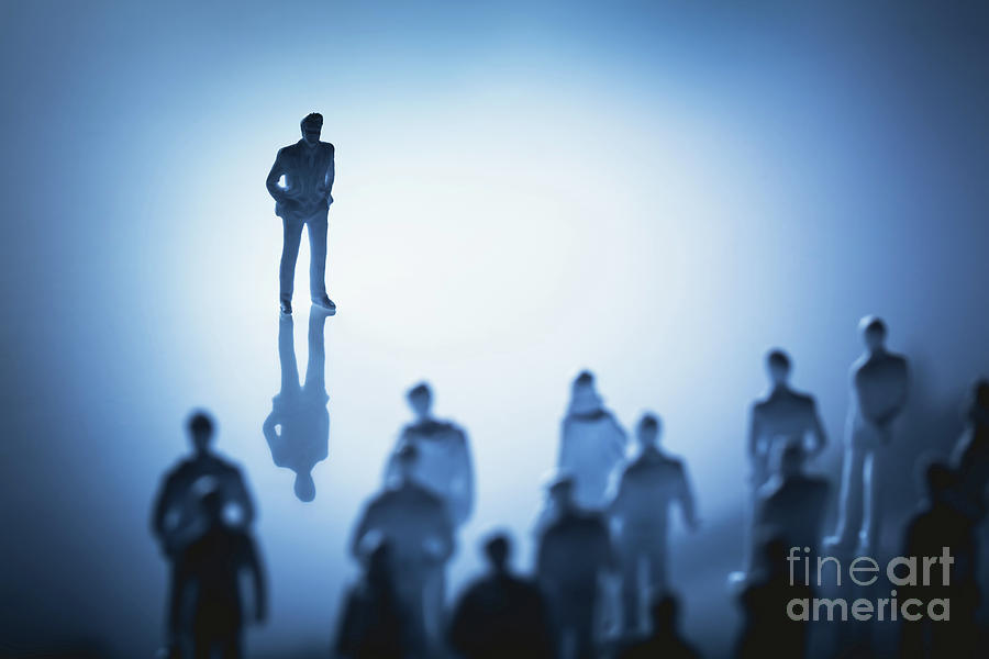 Single man standing in front of group of people. Photograph by Michal Bednarek