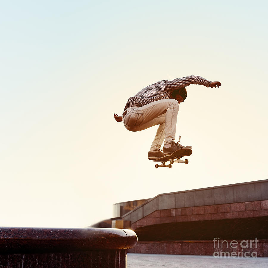 Skateboard Photograph - Skateboarder Performs A Trick by Maksim Shirkov