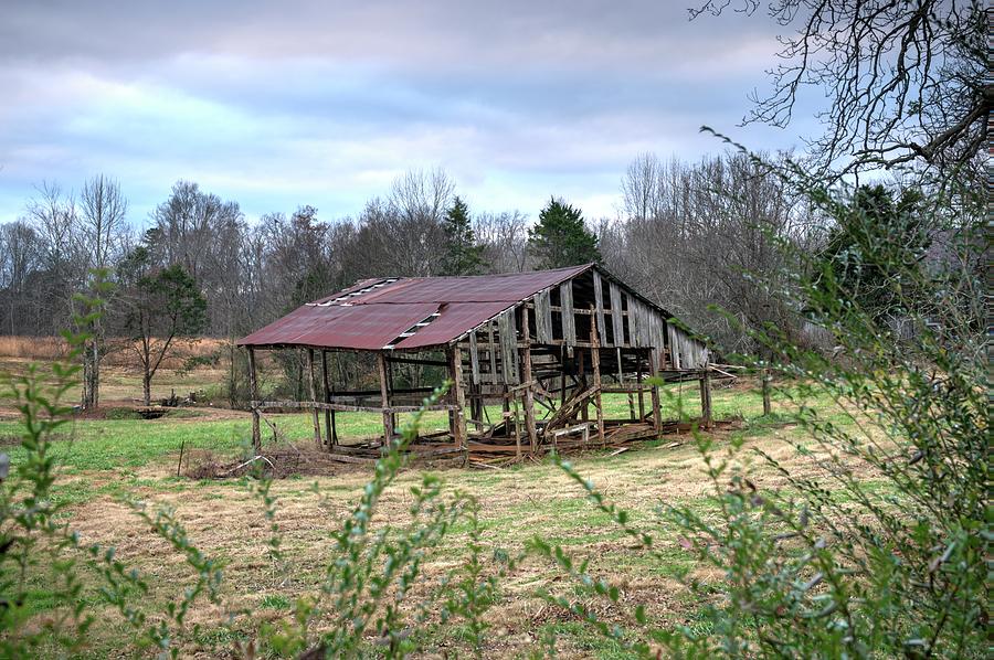 Skeleton Barn Under Darkening Sky Photograph