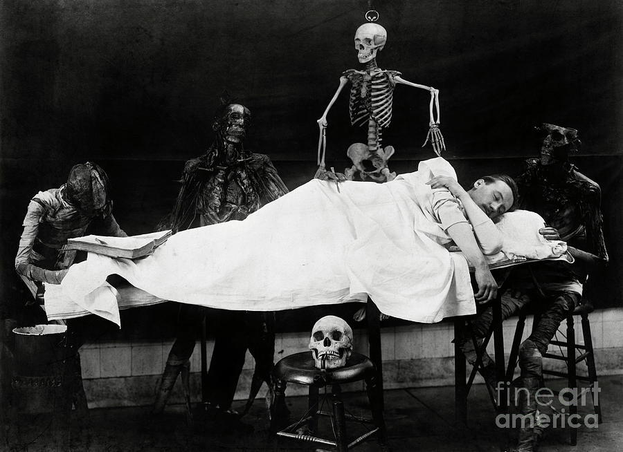 Skeletons Surrounding Sleeping Man Photograph by Bettmann