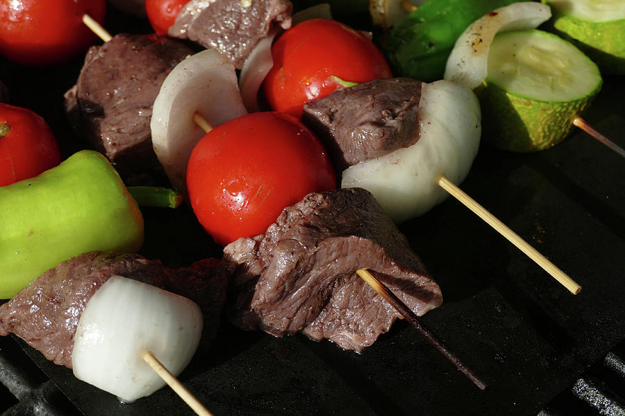 Skewers of lamb, tomato,onion and pepper on the grill Photograph by Steve Estvanik