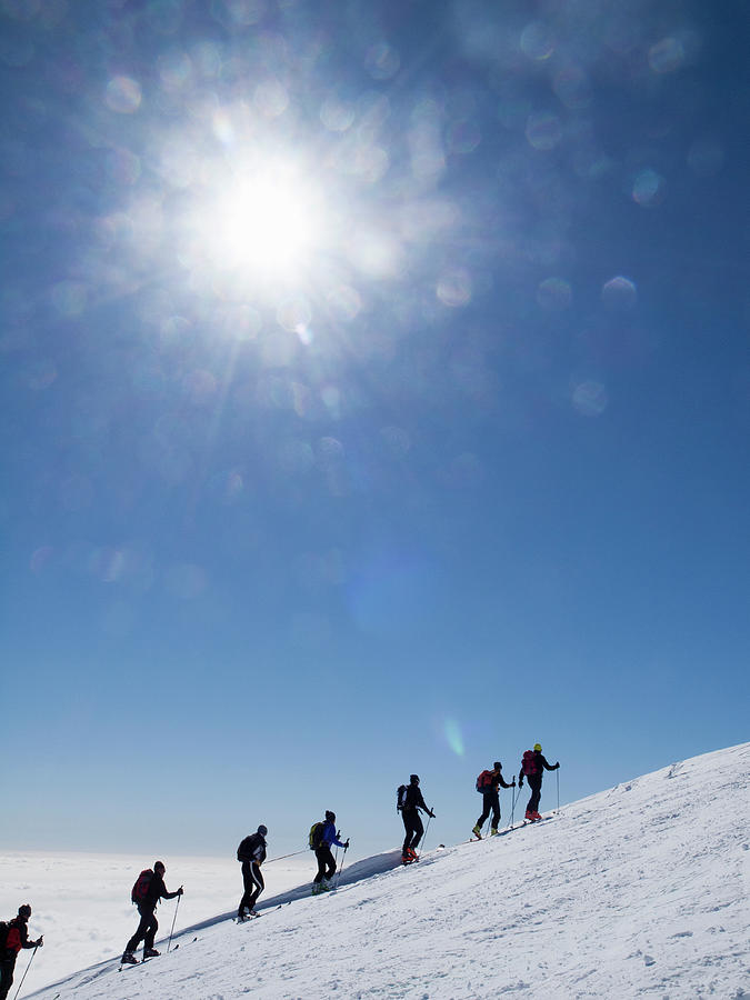 Skiers Ascending An Alpine Slope Photograph by Buena Vista Images