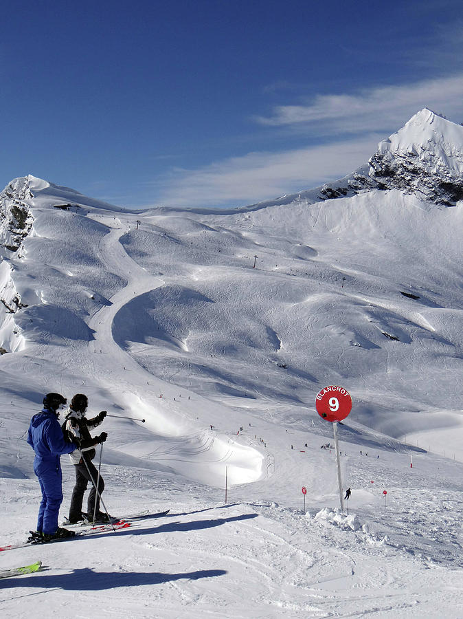 Skiers descend open slopes Photograph by Steve Estvanik