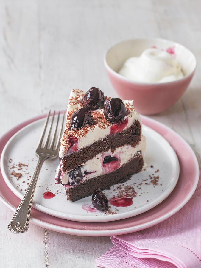 Slice Of Black Forest Gateau With Cherries And Bowl Of Cream Photograph by Michael Paul