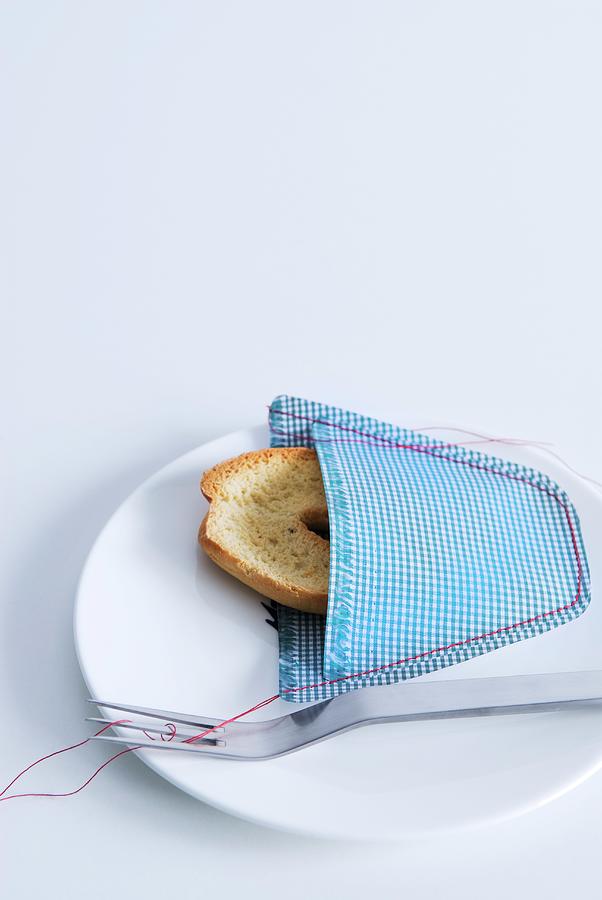 Slice Of Bread In Hand-sewn Decorative Pocket In Checked Fabric Photograph by Matteo Manduzio