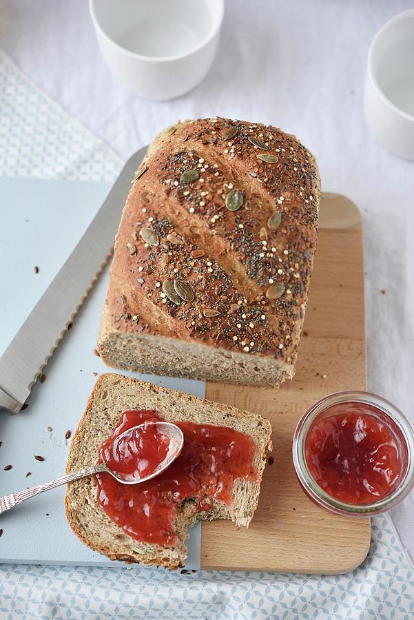 Slice Of Cereal Bread With Redcurrant Jam Photograph by Syl D Ab