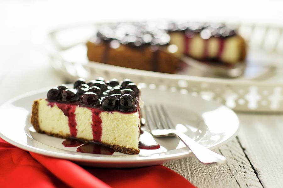 Slice Of Cheesecake With Blueberry Topping Photograph by Sam Henderson ...