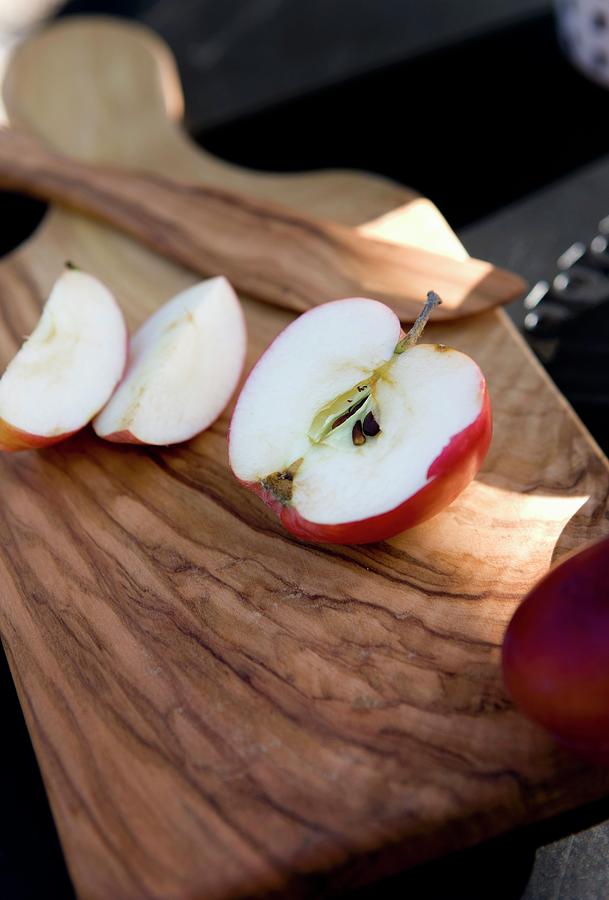 Sliced Apple On Wooden Chopping Board Photograph by Lene-k