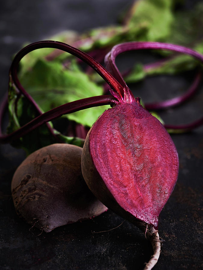 Sliced Beetroot With Leaves On A Black Background Photograph by Sylvia Meyborg