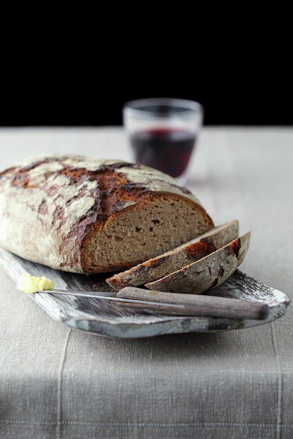 Sliced Bread With Red Wine And A Knife With Butter Photograph by Mona Binner Photographie