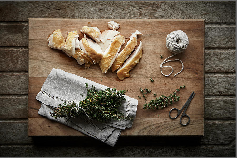 Sliced Chicken With Thyme On Wooden Chopping Board With Scissors And String Photograph by Cliqq Photography