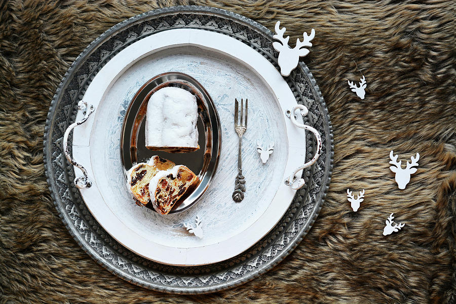 Sliced Christmas Stollen On An Artificial Fur Rug With Deer Decorations Photograph by Mariola Streim
