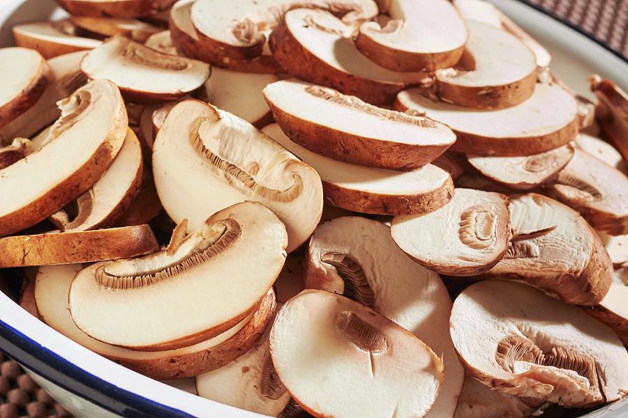 Sliced, Fresh Brown Mushrooms In An Enamel Bowl Photograph by Brian Yarvin