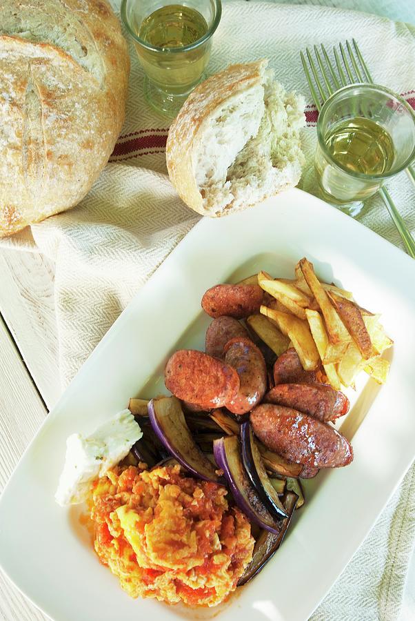 Sliced Greek Sausage With Roast Potatoes, Aubergines, Feta Cheese And Tomato Scrambled Eggs Photograph by Spyros Bourboulis