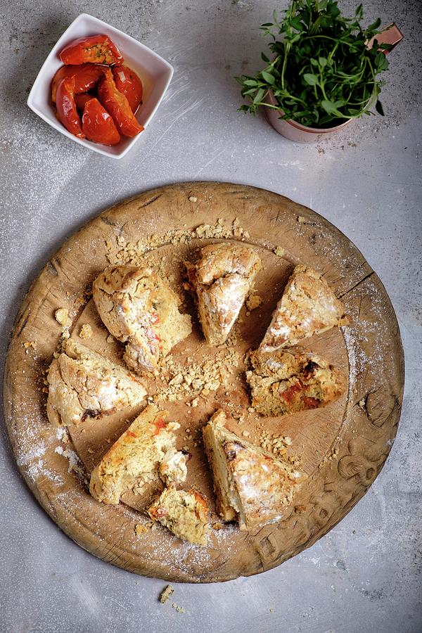 Sliced Irish Soda Bread With Tomatoes And Thyme On A Wooden Board Photograph by Adrian Britton