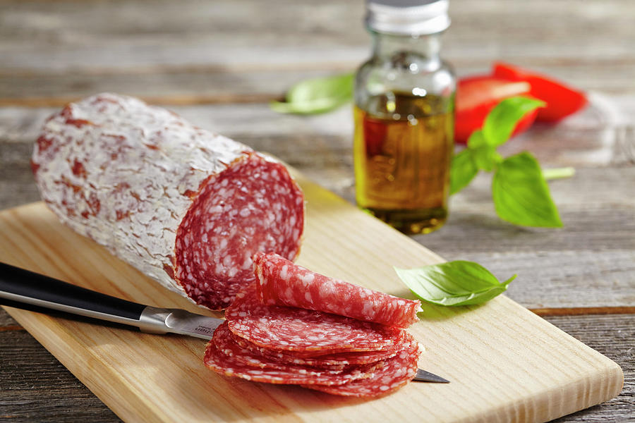 Sliced Milan Salami On A Wooden Board Photograph by Teubner Foodfoto