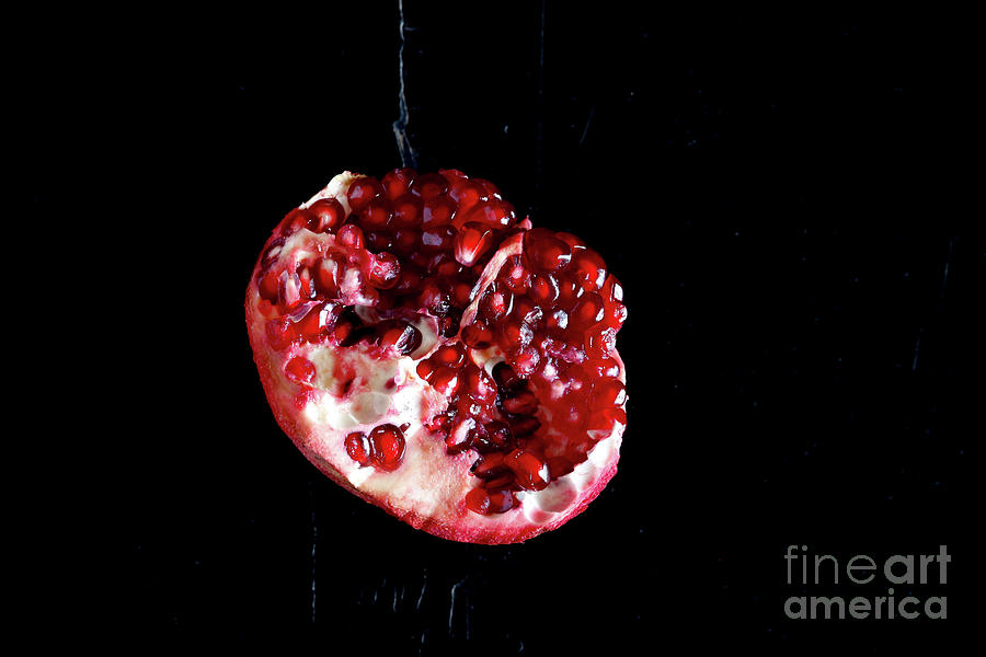 Sliced Pomegranate In Front Of Black Photograph by Westend61