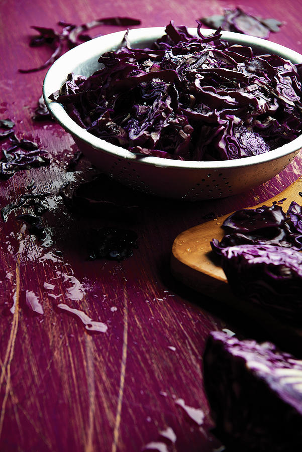 Sliced Red Cabbage In A Bowl With Some Scattered On The Table Photograph by Cliqq Photography