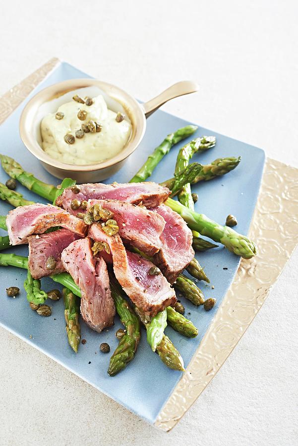 Slices Of Beef Steak On Green Asparagus With A Barnaise Caper Sauce Photograph by Great Stock!