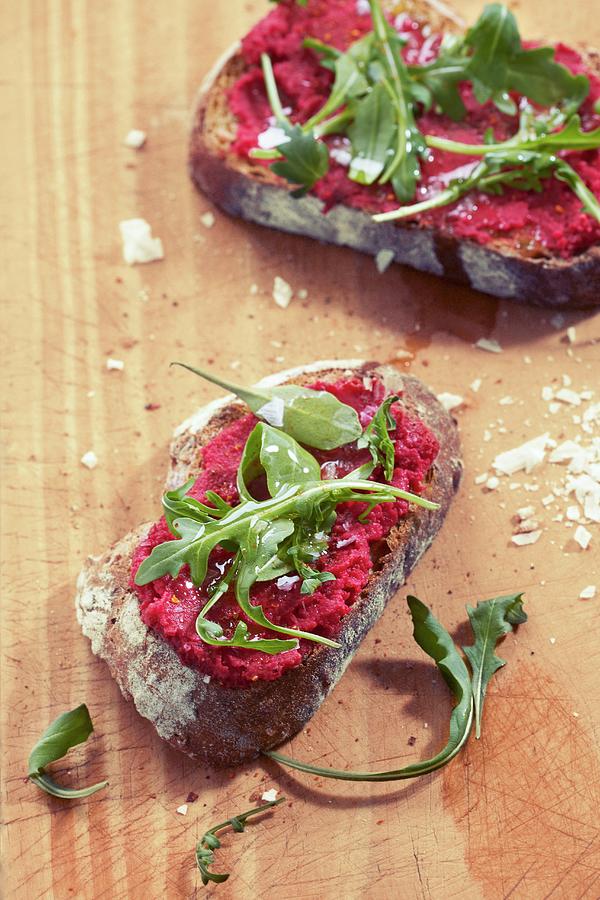 Slices Of Bread Topped With Beetroot Spread And Rocket Photograph by Miriam Rapado
