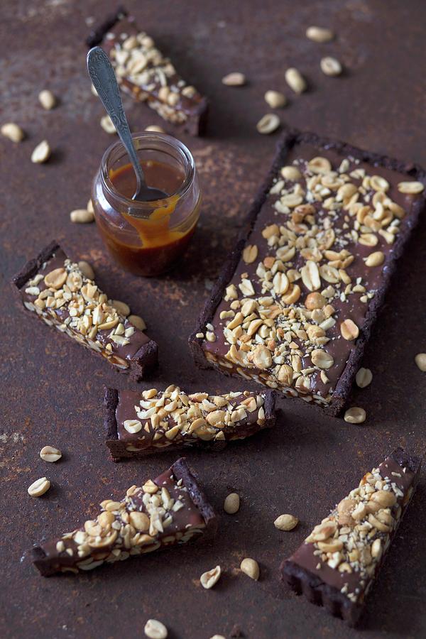Slices Of Chocolate Tart With Peanuts And Homemade Caramel Sauce Photograph by Malgorzata Laniak