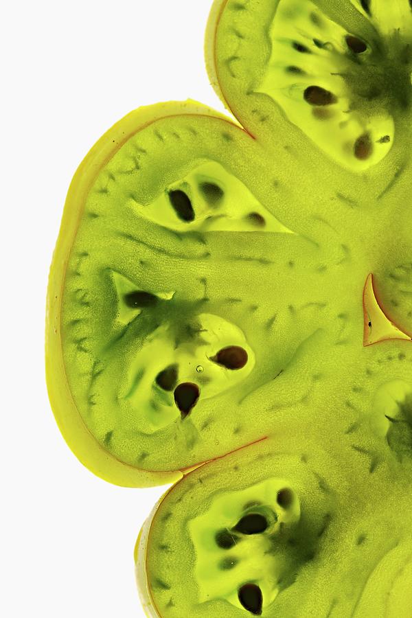 Slices Of Green Tomato Lit From Behind Photograph by Herbert Lehmann