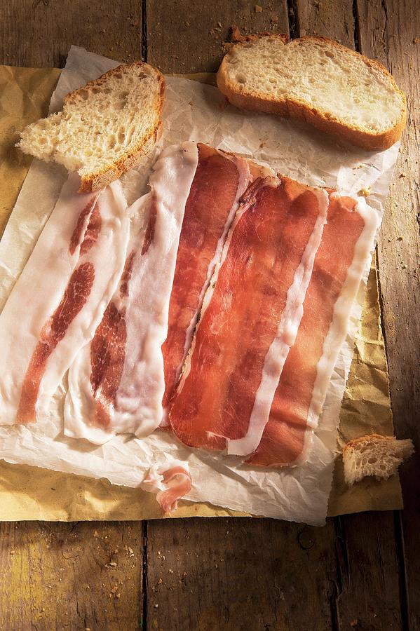 Slices Of Ham And Bread On A Piece Of Paper Photograph by Piga & Catalano S.n.c.