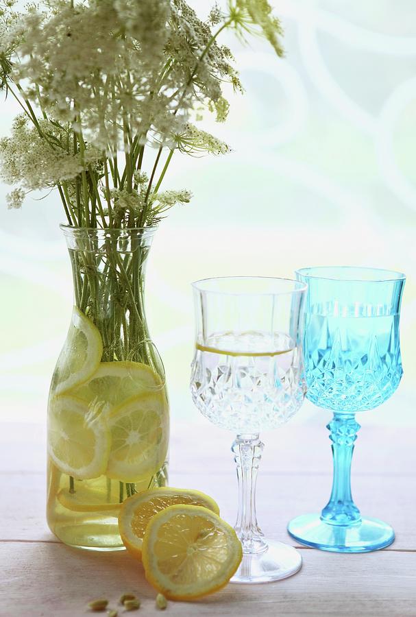 Slices Of Lemon And Bouquet Of Wild Flowers In Carafe Of Water Photograph by Sabrina Sue Daniels