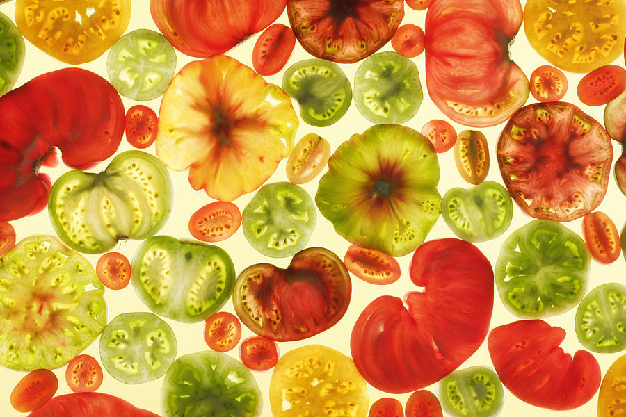 Slices Of Various Tomatoes On Colored Photograph by Paul Taylor