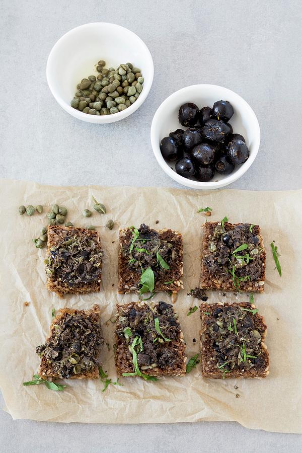 Slices Of Wholemeal Bread With Home-made Tapenade Photograph by Jan Wischnewski