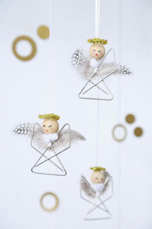 Small Angel Decorations Made From Paper Clips, Beads And Feathers Photograph by Thordis Rggeberg