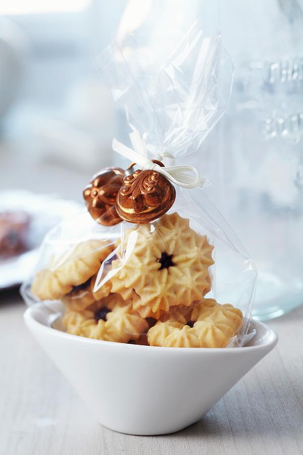 Small Bags Of Biscuits Decorated With Miniature Cake Moulds As Guest Favours Photograph by Franziska Taube