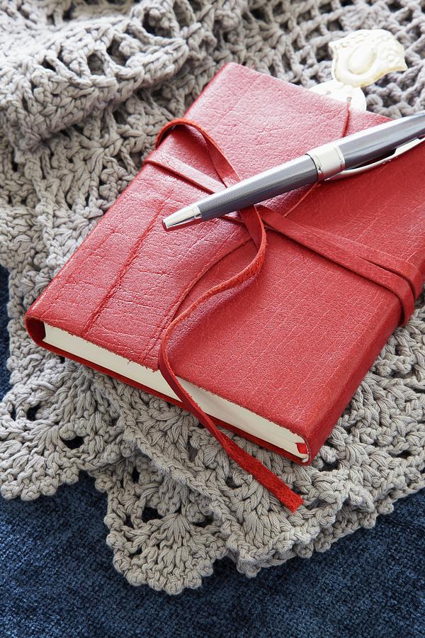 Small, Leather-bound Book On Crocheted Blanket Photograph by Great Stock!