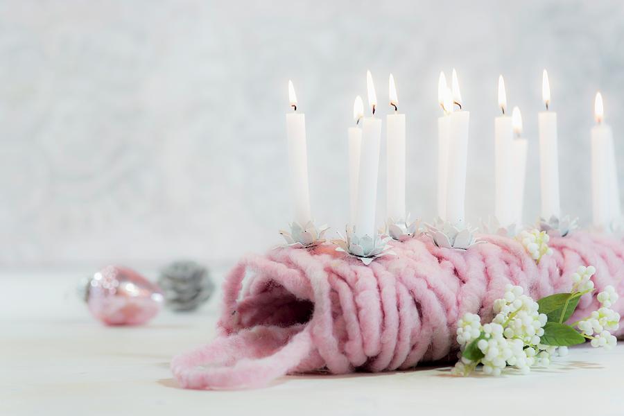 Small Lit Candles Stuck In Ball Of Pink Wool Photograph by Bildhbsch