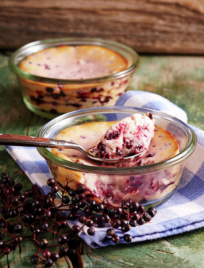 Small Portions Of Elderberry And Quark Bakes In Jars With Spoons Photograph by Teubner Foodfoto