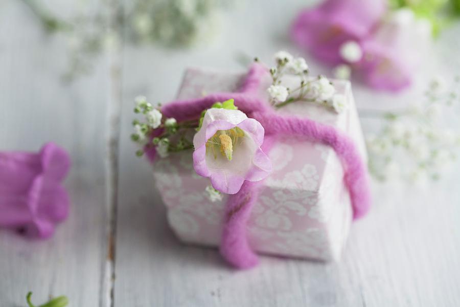 Small Present With Babys Breath, Bell Flowers And Lavender Felt Ribbon Photograph by Martina Schindler