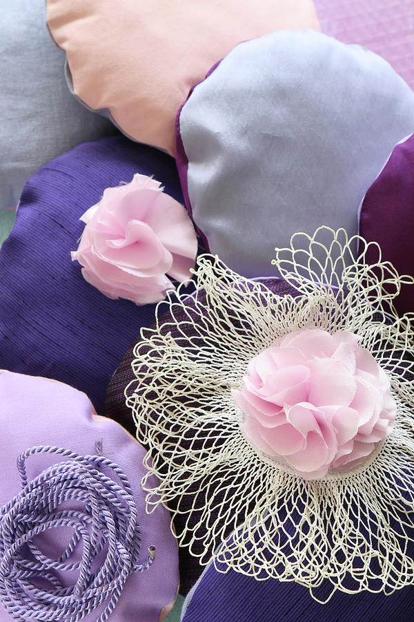 Small Round Cushions And Fabric Flowers In Various Shades Of Pink And Purple Photograph by Regina Hippel