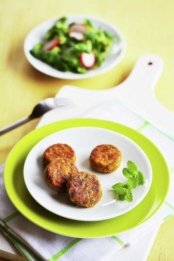 Small Vegetable Patties With A Plate Of Salad Photograph by Mariola Streim