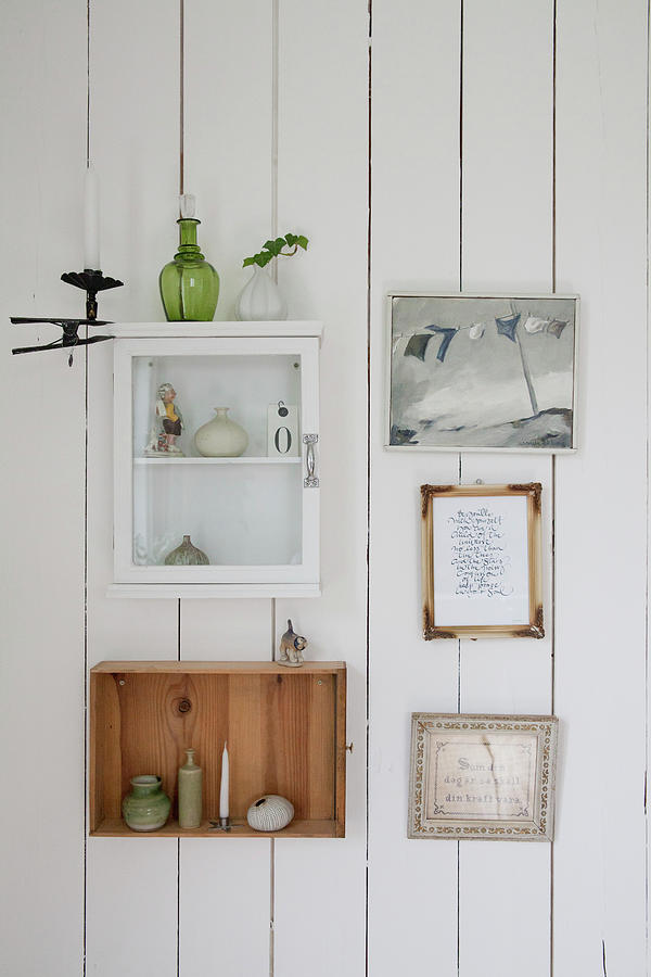 Small Wall Cabinet, Drawer On Side And Pictures Arranged On Board Wall Photograph by Camilla Isaksson