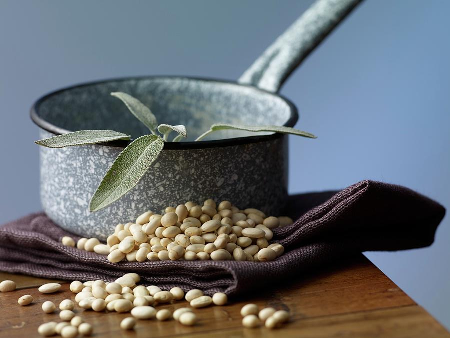 Small White Beans And Fresh Sage On Wooden Table Photograph by Studio R. Schmitz