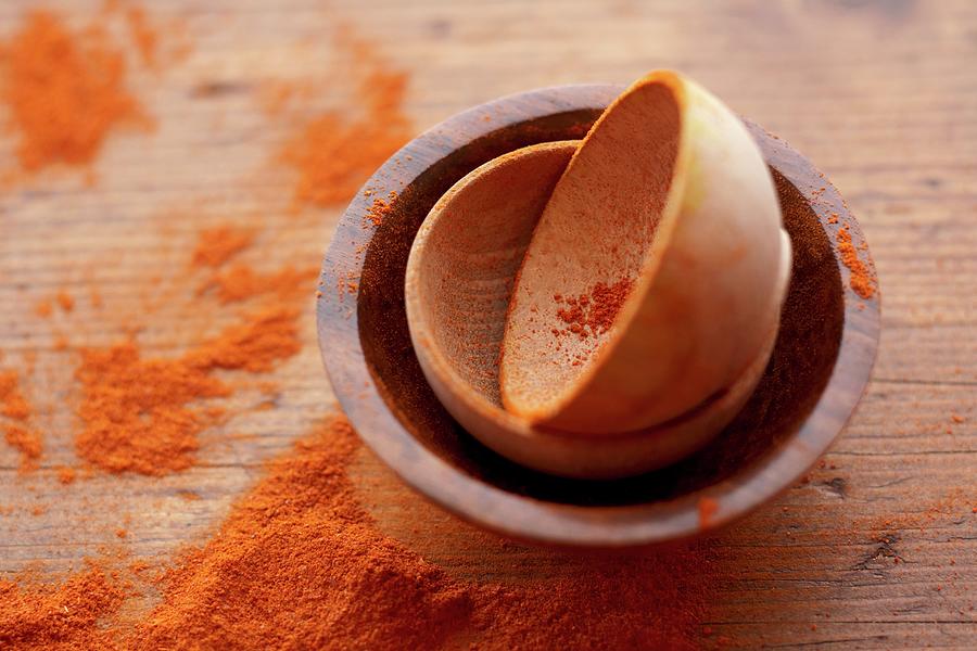 Small Wooden Bowls With Spilled Paprika Photograph by Edward Thomas